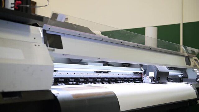 The process of printing a large-format printer in the production workshop of the printing house. Production of printing products