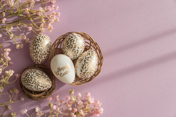 Pastel Easter Eggs with Gold Details and Flowers into Nest on Lavender Background