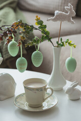 Spring Table Decor with Bunny Figurines, Hanging Eggs and Floral Cup of Coffee
