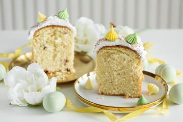 Cutted Easter Cake Decorated Yellow Ribbon with Flowers and Pastel Eggs on White Background