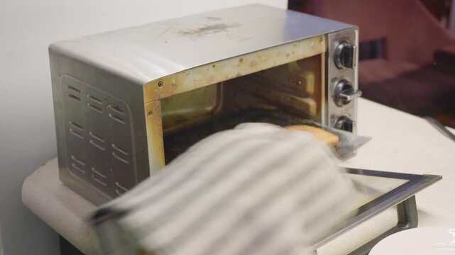 Close-up, escaped view of a toaster oven with two slices of bread.