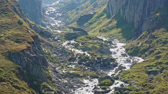 Mountain Stream Flowing Through Rocky Valley &ndash; Swiss Alps Aerial View