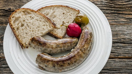 Liver sausage served with bread and pickled vegetables on a plate