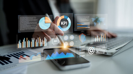 A professional woman engages with a holographic interface displaying performance data and analytics for informed business decision making in a modern office environment. Gantry