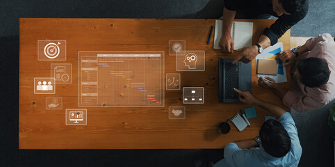 A diverse team collaborates on project planning, using digital tools and visual elements to enhance productivity and workflow efficiency during a strategic meeting. Trope