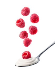 Spoon of fresh greek yogurt and falling raspberries on white background