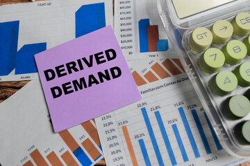 Concept of derived demand write on sticky notes isolated on Wooden Table.