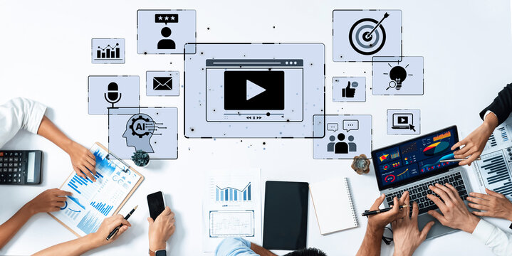 A diverse business team collaborates to develop digital marketing strategies, focusing on video content and data analysis in a dynamic office environment. Trope - Powered by Adobe