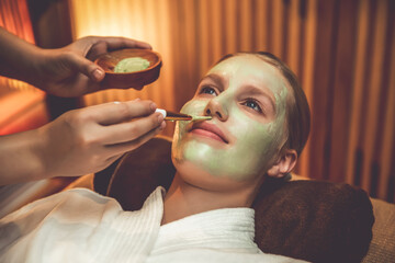 Serene ambiance of spa salon, woman customer indulges in rejuvenating with luxurious face cream...