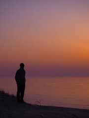 Back View Of Man Looking At Colorful Baltic Sea Horizon In Nida At Golden Hour