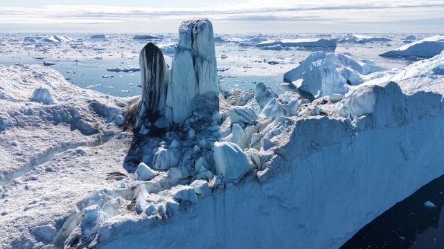 GREENLAND - 11.4.2025 - Great aerial footage moving over a large iceberg on Greenland's Disko Bay.