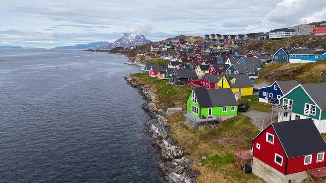 GREENLAND - 11.4.2025 - Incredible aerial footage moving up the coastline of Nuuk, Greenland, filled with colorful houses.