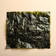 A sheet of crispy seaweed on a beige background