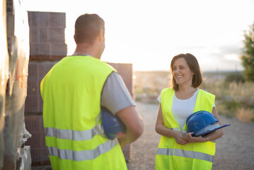 Outdoor Images of a Thirty Five Year Old Man and Woman Construction Workers Planning Work Talking and Taking a Break