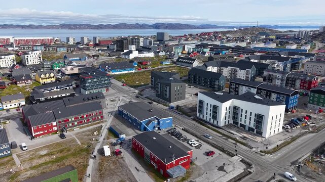 GREENLAND - 11.4.2025 - Excellent aerial footage moving over a busy coastal sector of Nuuk, Greenland.
