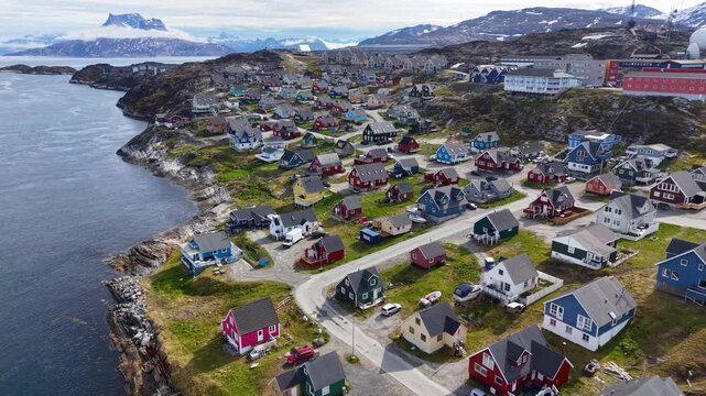 GREENLAND - 11.4.2025 - Gorgeous aerial footage pulling back from colorful houses on the coast of Nuuk, Greenland.