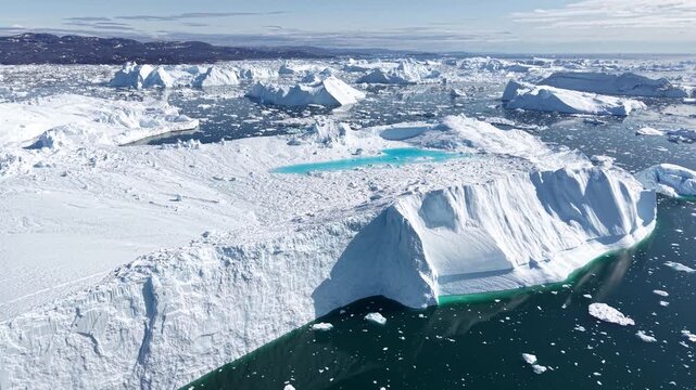 GREENLAND - 11.4.2025 - Great aerial footage passing a scenic ice field on Greenland's Disko Bay.