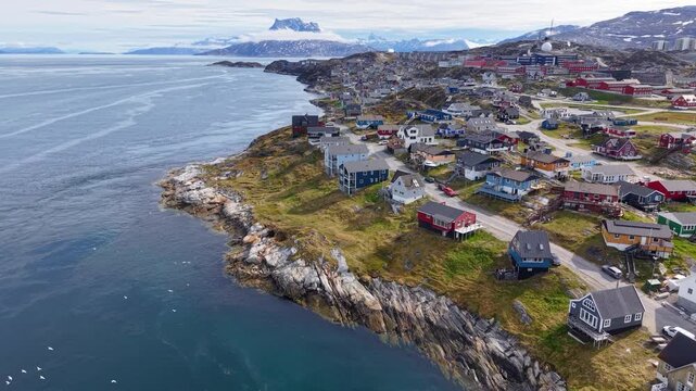 GREENLAND - 11.4.2025 - Terrific aerial footage moving up the coast of Nuuk, Greenland, towards a misty mountain.