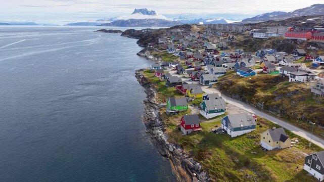 GREENLAND - 11.4.2025 - Excellent aerial footage moving up the coastline of Nuuk, Greenland, towards a misty peak.