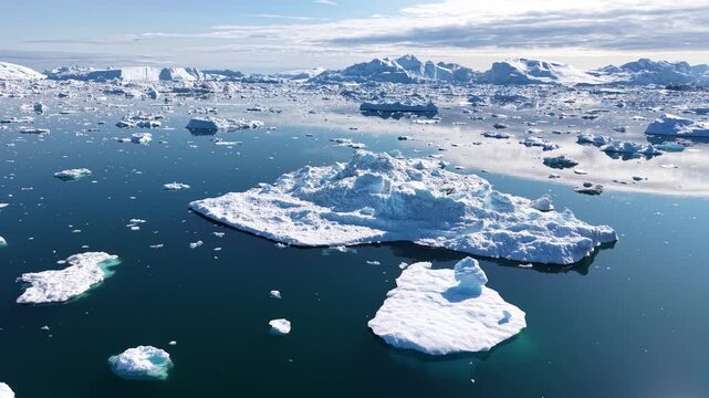 GREENLAND - 11.4.2025 - Excellent aerial footage circling a small iceberg on Greenland's Disko Bay.
