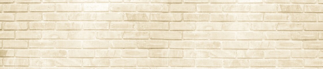 Fototapeta premium Light beige brick wall texture background with clean stone surface and panoramic horizontal layout