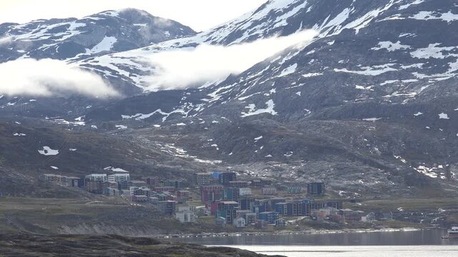 GREENLAND - 11.4.2025 - Breathtaking aerial view of misty snow-covered mountains in Nuuk, Greenland.