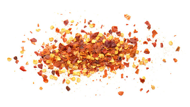 Pile of red chili flakes isolated on white, top view