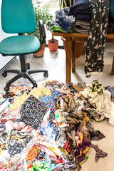 Close-up of mixed colorful fabric scraps in fashion studio, symbolizing textile design, reuse, creativity, and sustainable clothing production.