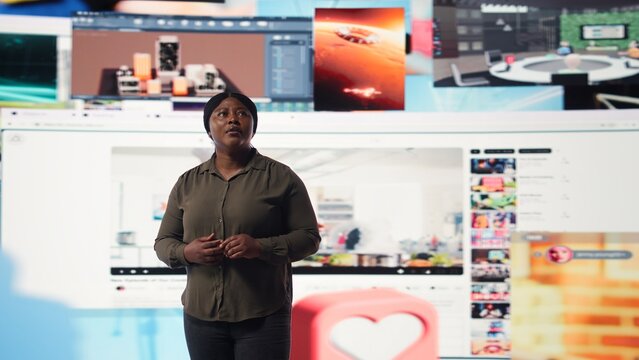 Person watches multimedia collage of modern social media networks videos. African american woman looks at visualization of data driven world with content in constant motion, camera A - Powered by Adobe