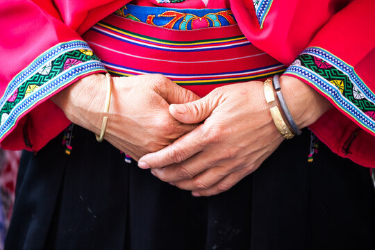 Close Up View of Hands of chinese woman wearing colorful ethnic dress, China