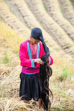 Chinese woman with long hair at a rice terrace, Guilin, China