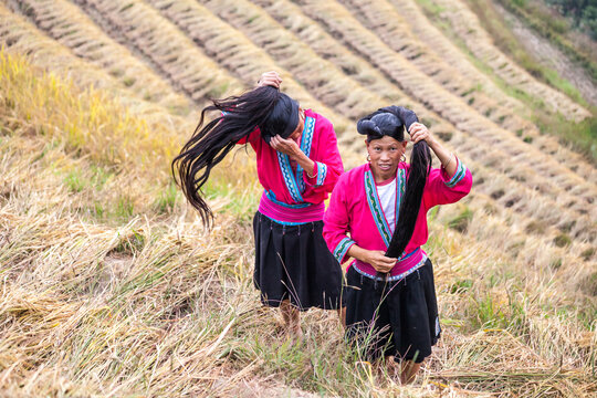 Two Yao ethnic minority woman with long hair at a rice terrace, Guilin, China