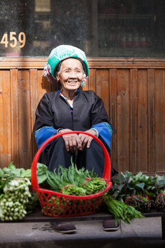 Senior chinese Zhuang minority woman with Large Basket of Fresh Produce, Guilin, China