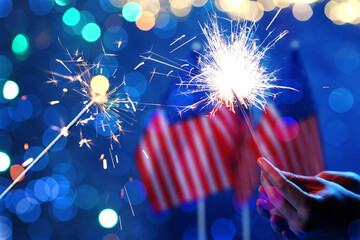 American holiday greeting card design with burning sparklers, USA flags and bokeh lights © New Africa