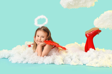 Naklejka premium Cute little girl dressed as cupid lying on cloud against blue background. Valentine's Day celebration