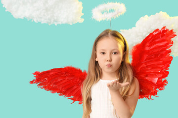 Naklejka premium Cute little girl dressed as cupid blowing kiss near clouds on blue background. Valentine's Day celebration