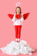 Fototapeta premium Cute little girl dressed as cupid with gift box on cloud against pink background. Valentine's Day celebration