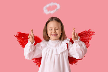 Fototapeta premium Cute little girl dressed as cupid making wish on pink background. Valentine's Day celebration