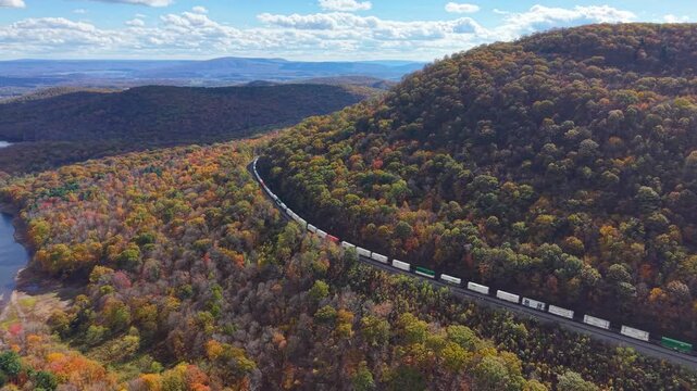 PENNSYLVANIA - 11.10.2025 - Beautiful aerial footage of a freight train rounding Pennsylvania's Horseshoe Curve, surrounded by autumn trees.