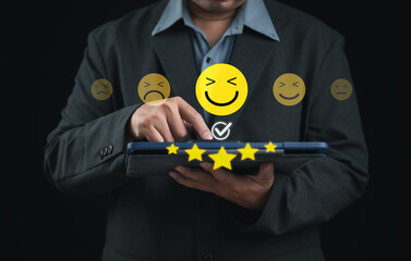 Customer satisfaction concept with user selecting happy smiley and five star rating on digital tablet interface, representing positive feedback, service quality evaluation, user experience, and custom