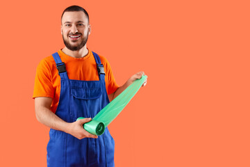 Male scavenger with garbage bags on orange background