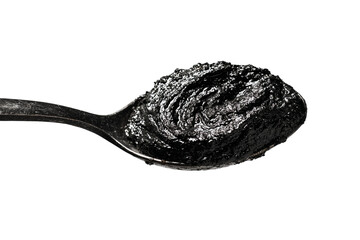 Spoonful of Black Substance on White Background