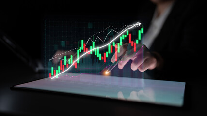 A futuristic hand engages with a digital stock market chart, highlighting growth and investment analysis through vibrant graphics and data interpretation. Impute