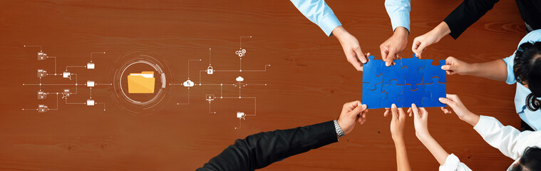 Diverse team members collaboratively engage in problem-solving using puzzle pieces to illustrate connection while digital icons represent innovation in the workplace. Trope