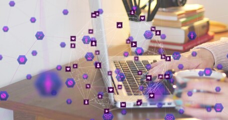 Typing person's hands with knit sleeve using open laptop on home desk, with purple network overlay