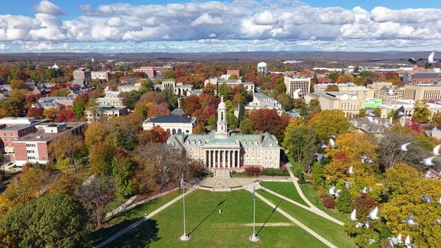 PENNSYLVANIA - 11.10.2025 - Terrific aerial footage circling clockwise around Penn State University's Old Main building.