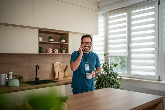 Male healthcare worker smiling during phone call break