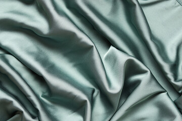 Fototapeta premium Texture of green satin fabric as background
