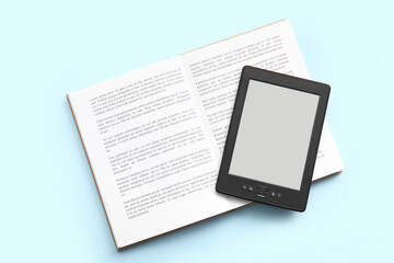 Obraz premium Modern e-reader with book on blue background