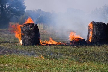 The grass fire moved into the hay bales  © SnapWild Photogrpahy